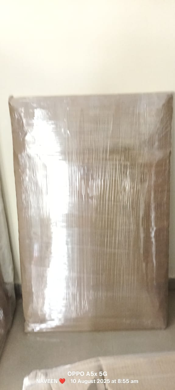 Staff dismantling modular king size cot and labeling mounting screws